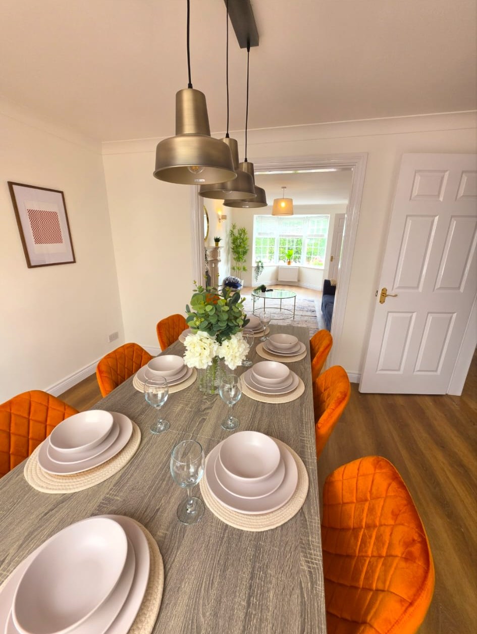 Finished dining room with orange velvet chairs, staged by CLP Staging