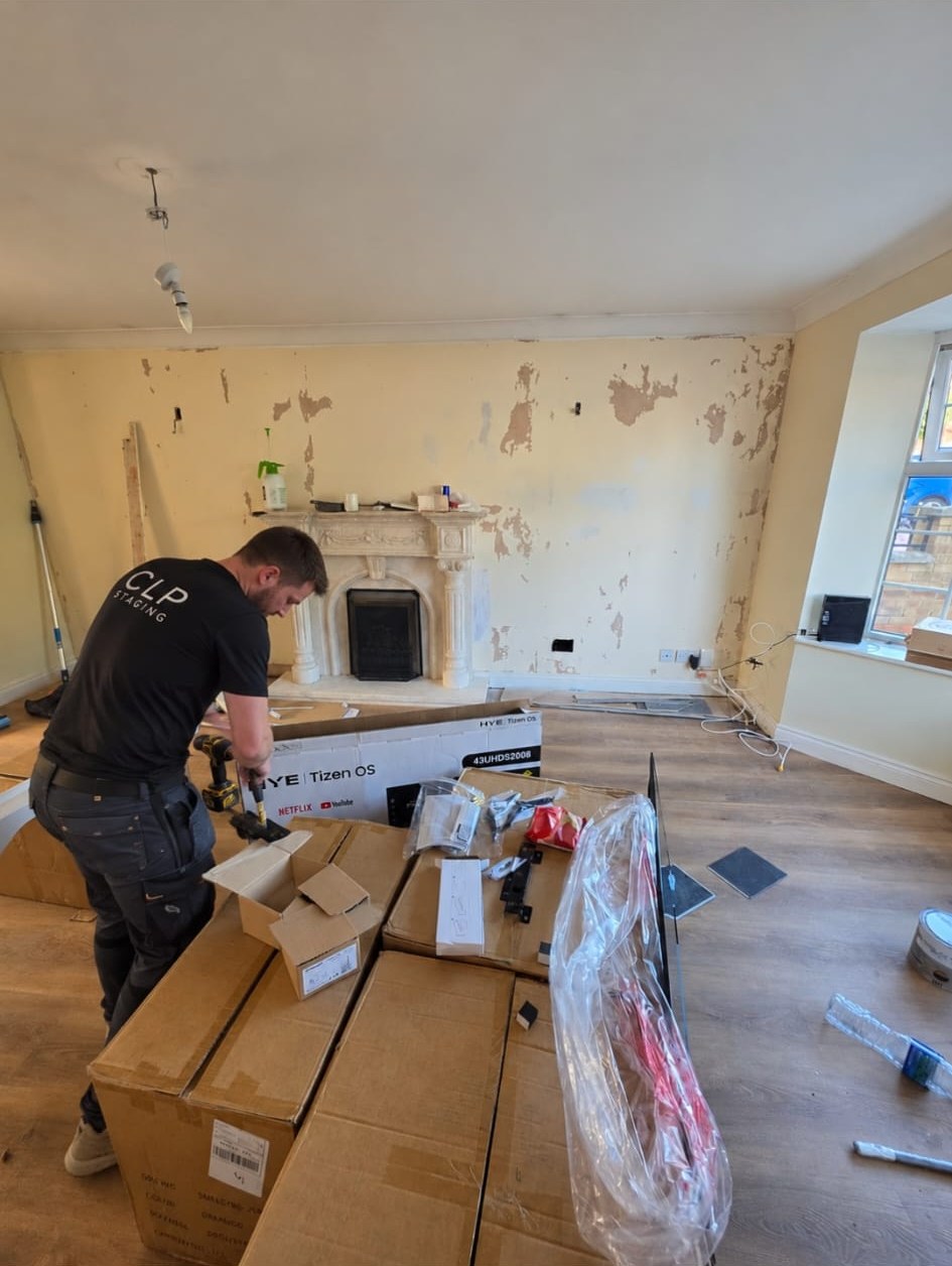CLP installer in a branded top unpacking boxes during an installation