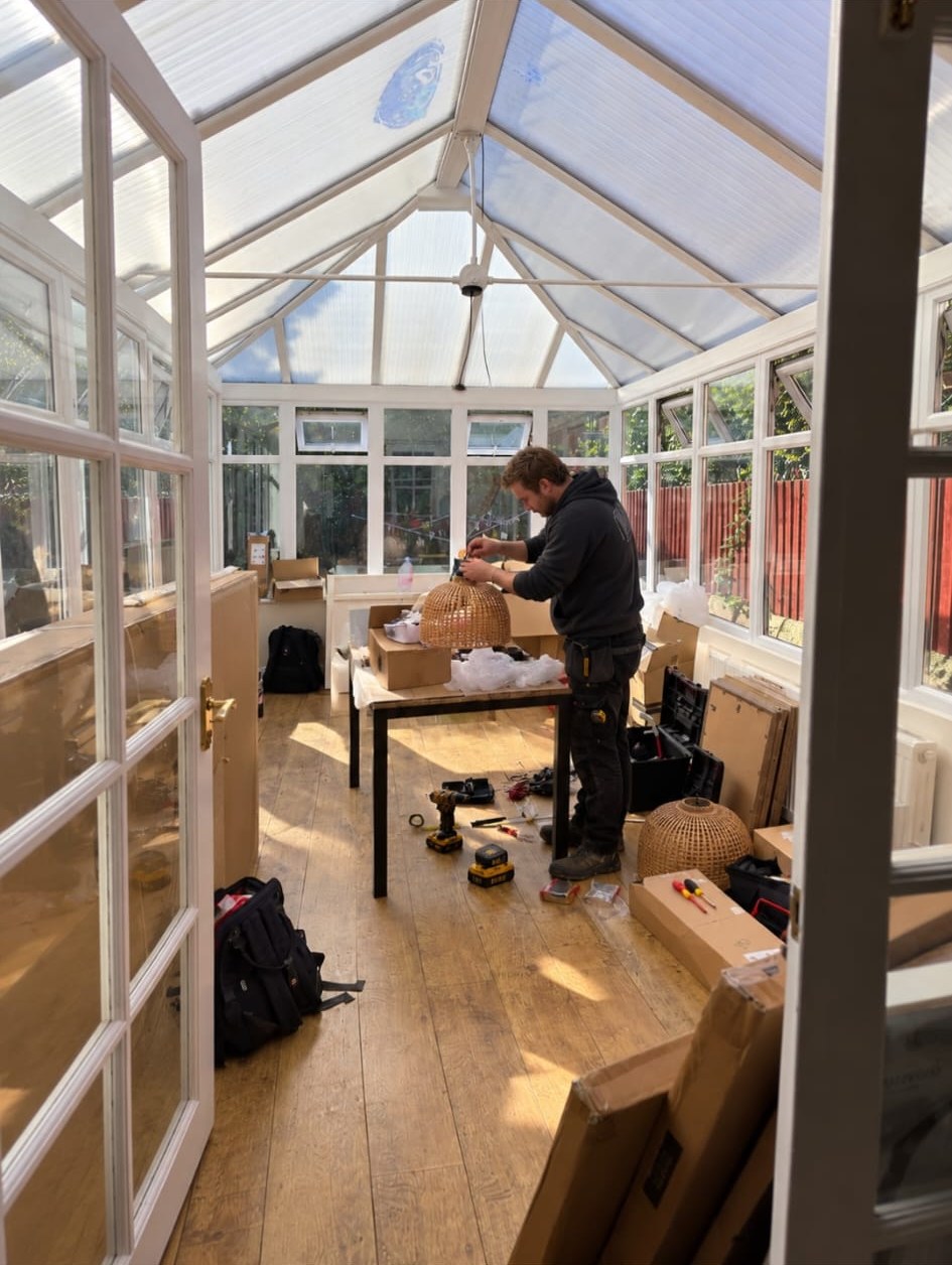CLP fitter assembling lighting in a conservatory during installation